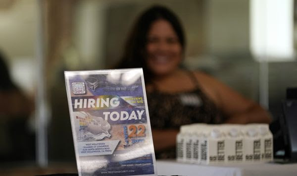 A hiring sign is placed at a booth for prospective employers during a job fair Wednesday, Sept. 22, 2021, in the West Hollywood section of Los Angeles. (AP Photo/Marcio Jose Sanchez, File)