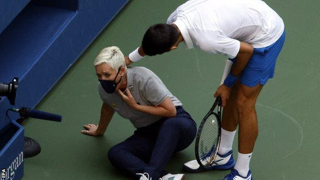 Novak Djokovic checks on the line judge after hitting her with a ball
