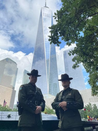 Two ECOs standing at the site of the World Trade Center attacks to pay their respects