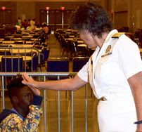 Dr. Lurie gives a high-five to a survivor in a shelter following the Louisiana flood