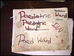 The figure above is a photograph showing a homemade sign for a pediatric ward in Sierra Leone.