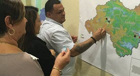 Disaster recovery personnel from ASPR looking at map of Puerto Rico