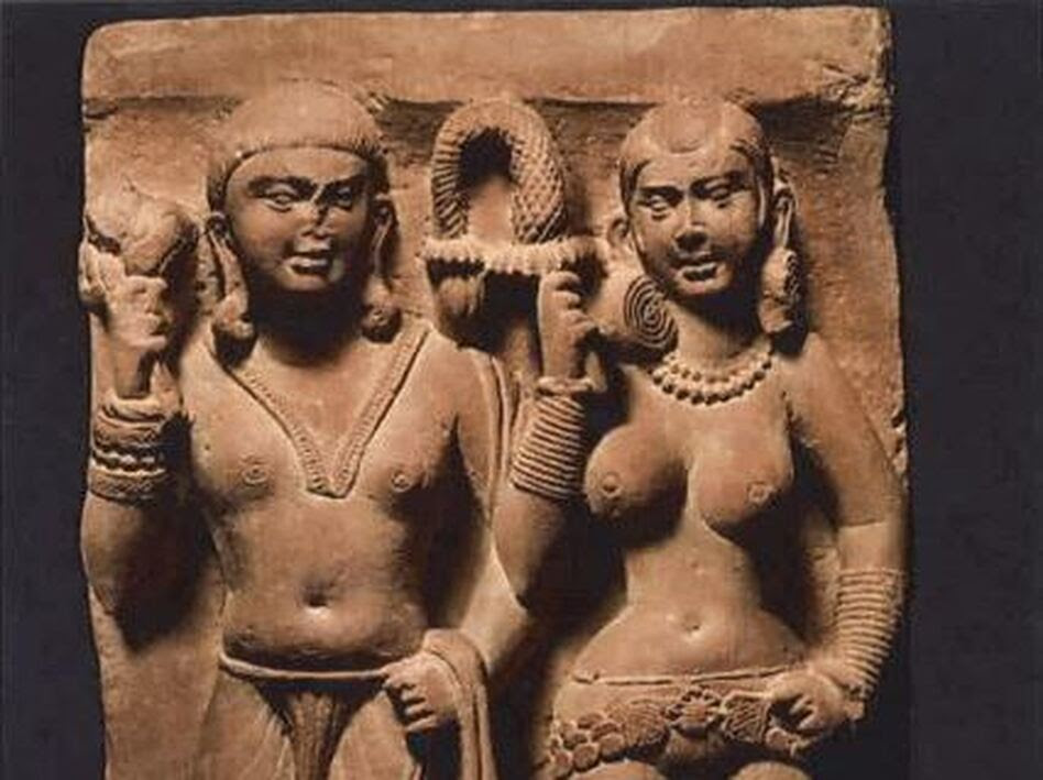 A red sandstone relief of 2 figures, originally found in India