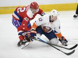 Washington Capitals defenseman Martin Fehervary (42) and New York Islanders right wing Leo Komarov (47) battle for the puck during the second period of an NHL hockey game, Monday, Feb. 10, 2020, in Washington. (AP Photo/Nick Wass)