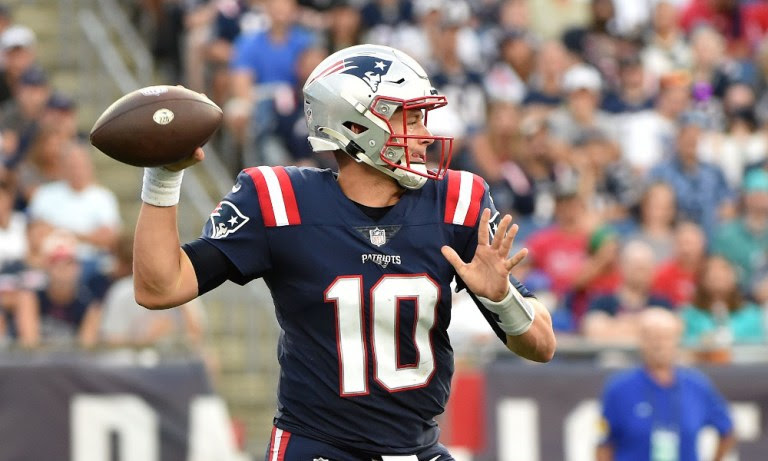 Mac Jones attempts a pass for New England Patriots in 2021 game