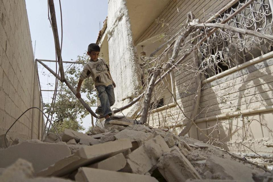 Boy in rubble, Syria