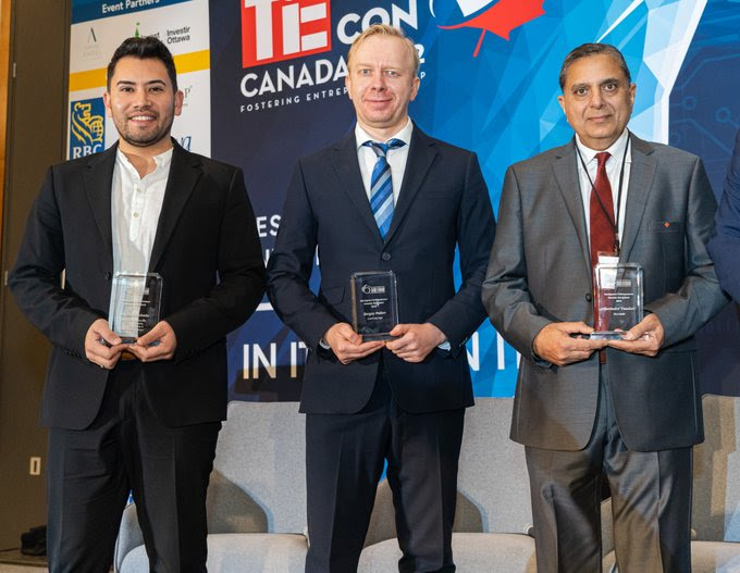 Group shot of the winners of the 2022 Immigrant Entrepreneur Awards holding their trophies.