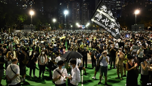 FILE - Activists hold a candlelit remembrance in Victoria Park in Hong Kong on June 4, 2020.
