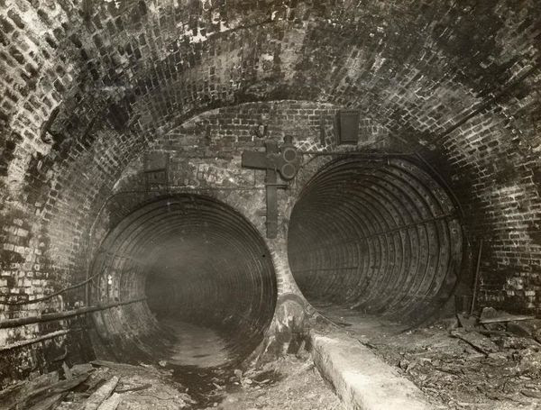 Two smaller circular tunnels leading into a larger one