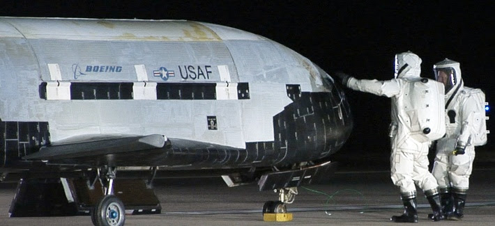 Air Force
personnel conduct checks on the X-37B vehicle after
a landing at Vandenberg Air Force Base, on December
3, 2010. Air Force personnel conduct checks on the X-37B
vehicle after a landing at Vandenberg Air Force
Base, on December 3, 2010.