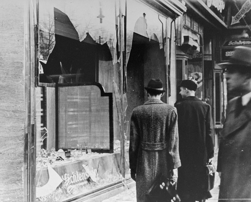 Shattered storefront of a Jewish-owned shop destroyed during Kristallnacht (the "Night of Broken Glass").
