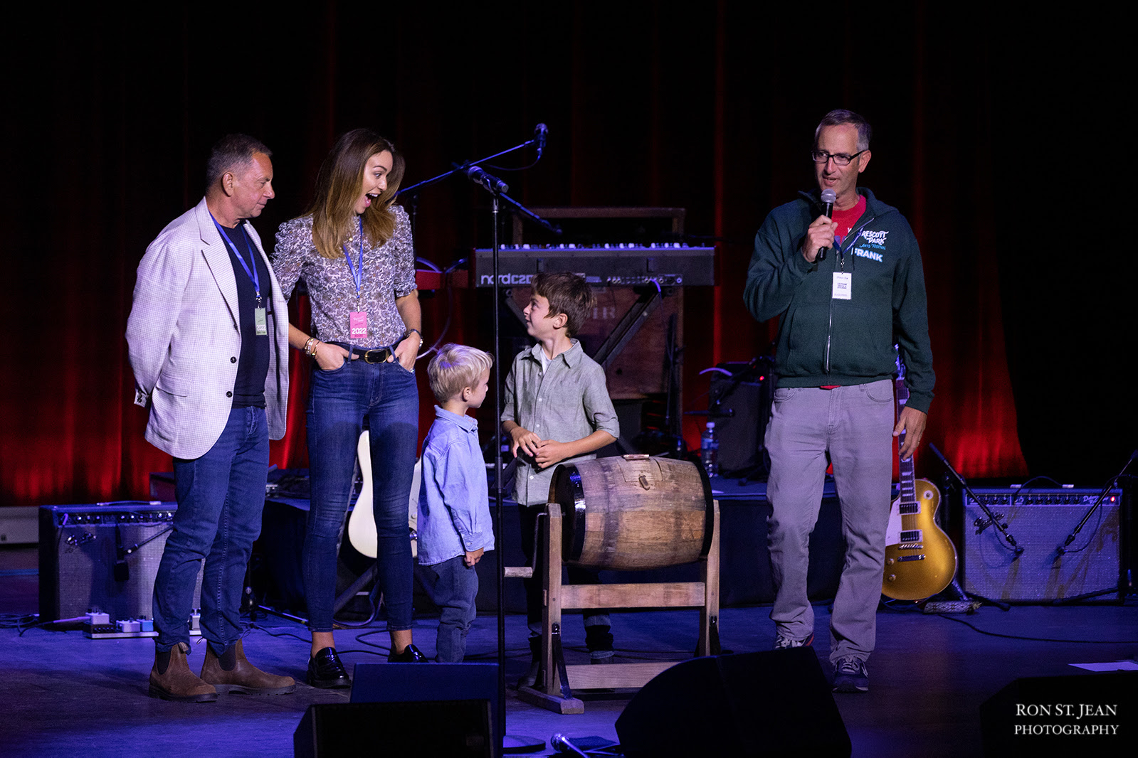 The DiLorenzo family stands onstage with the raffle drum at the Allen Stone concert