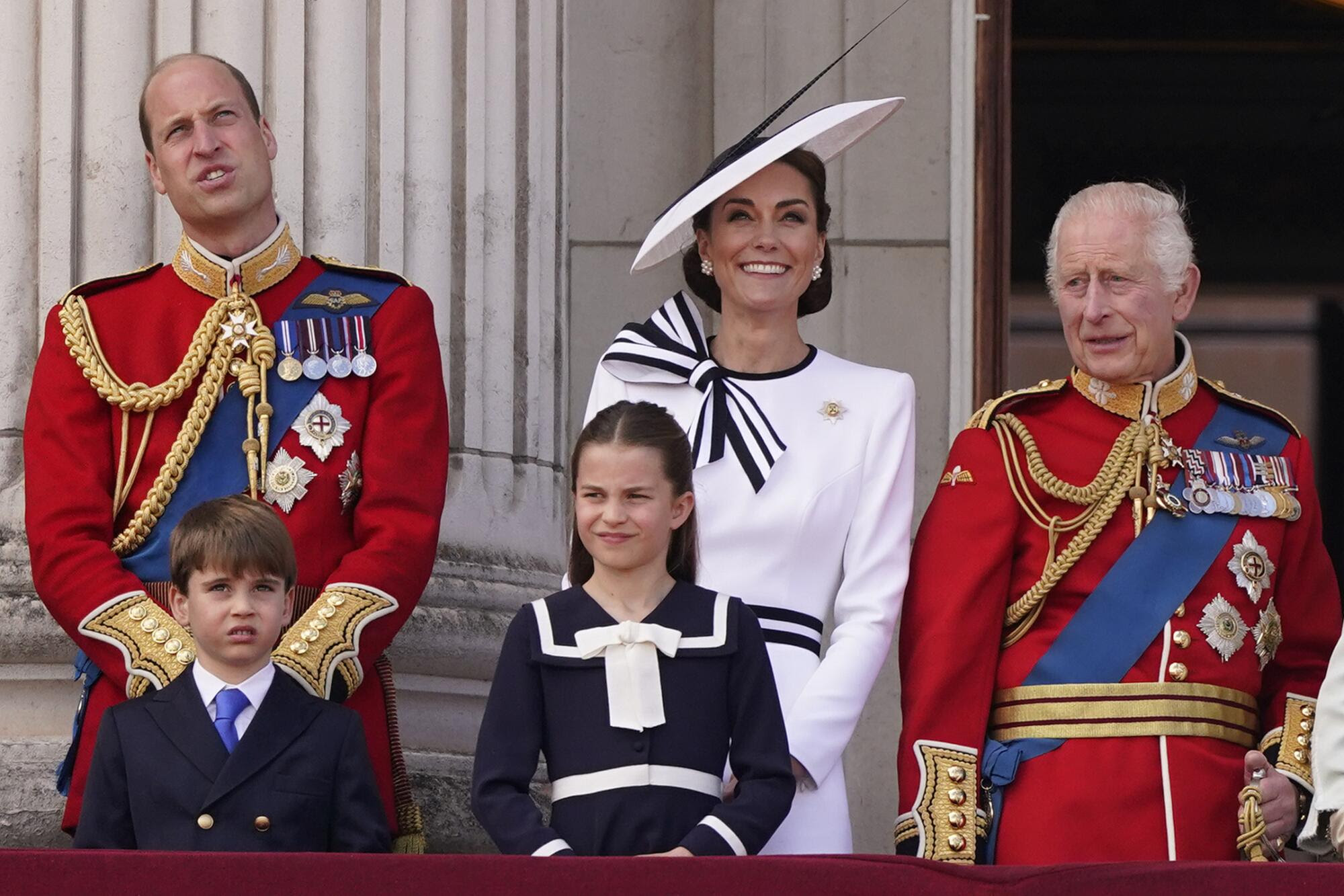 Prince William and Kate Middleton with two children and King Charles.