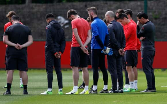 United players and staff stand for a minute’s silence during training, before Wednesday’s Europa League final in Stockholm.