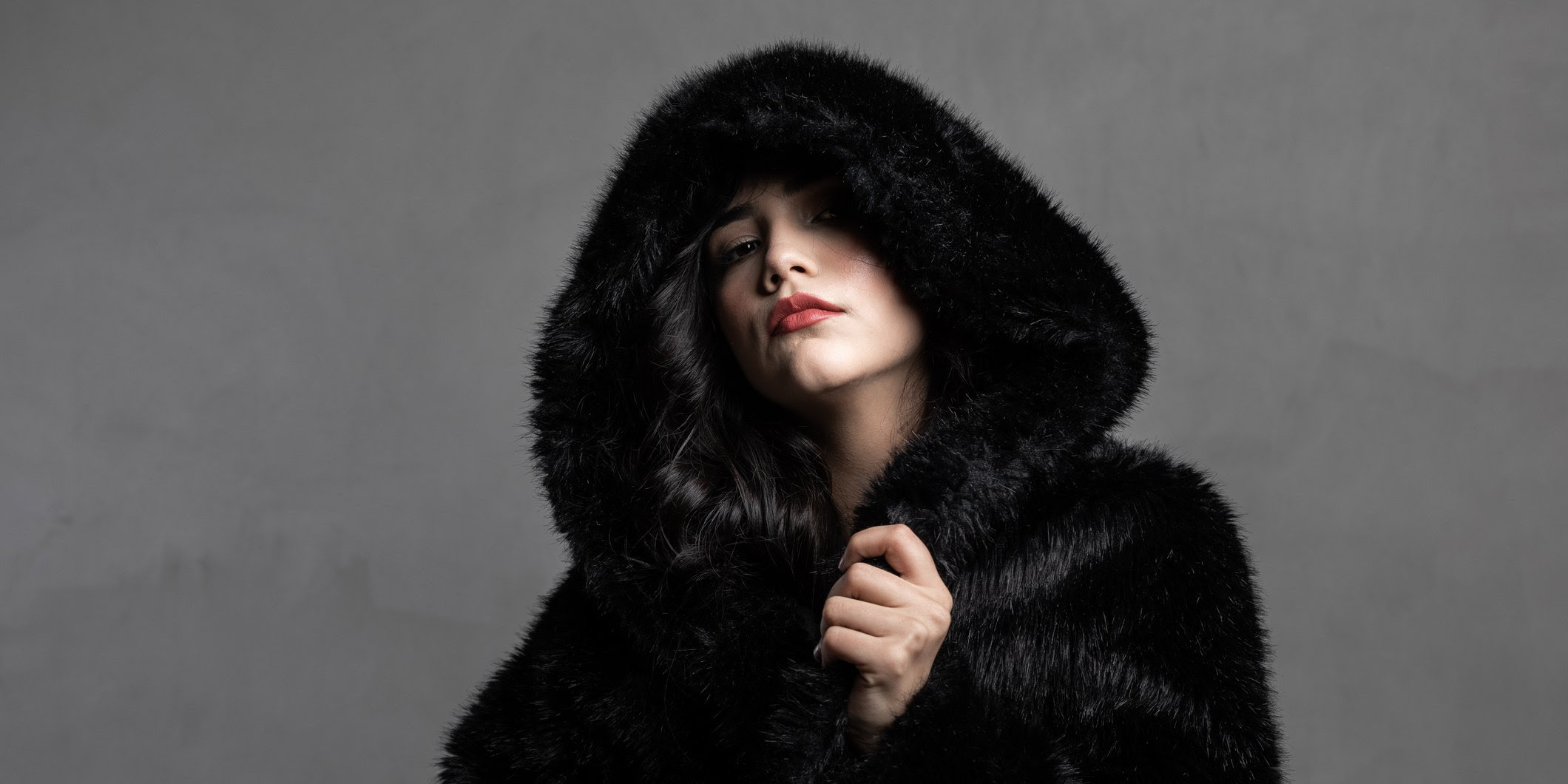 A woman proudly wearing a fur coat