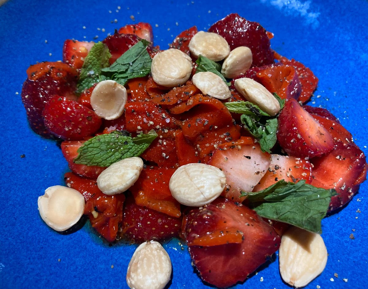 a strawberry and Piquillo pepper salad on a blue plate