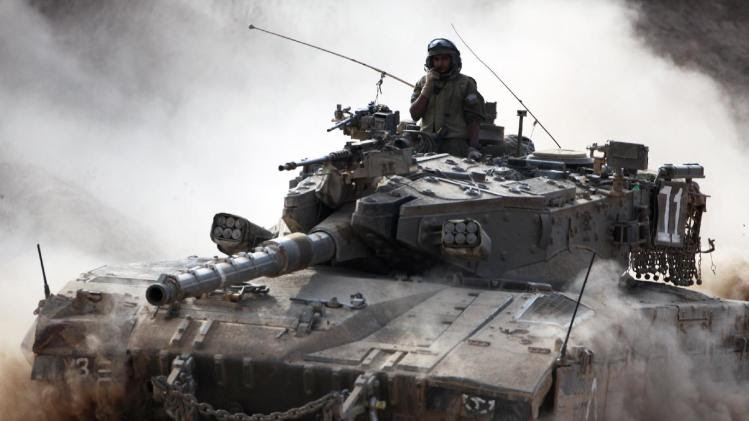 An Israeli army Merkava tank rolls along the border between Israel and the Hamas-controlled Gaza Strip on July 28, 2014