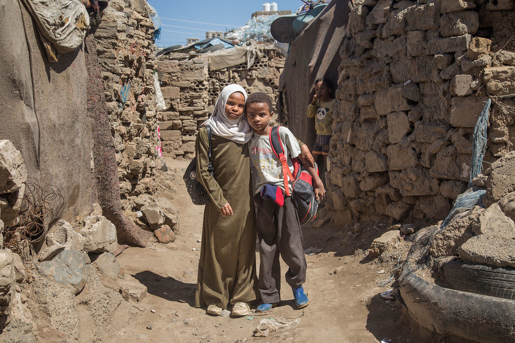 A twelve-year-old Yemeni girl and her younger brother who she tutors in mathematics.