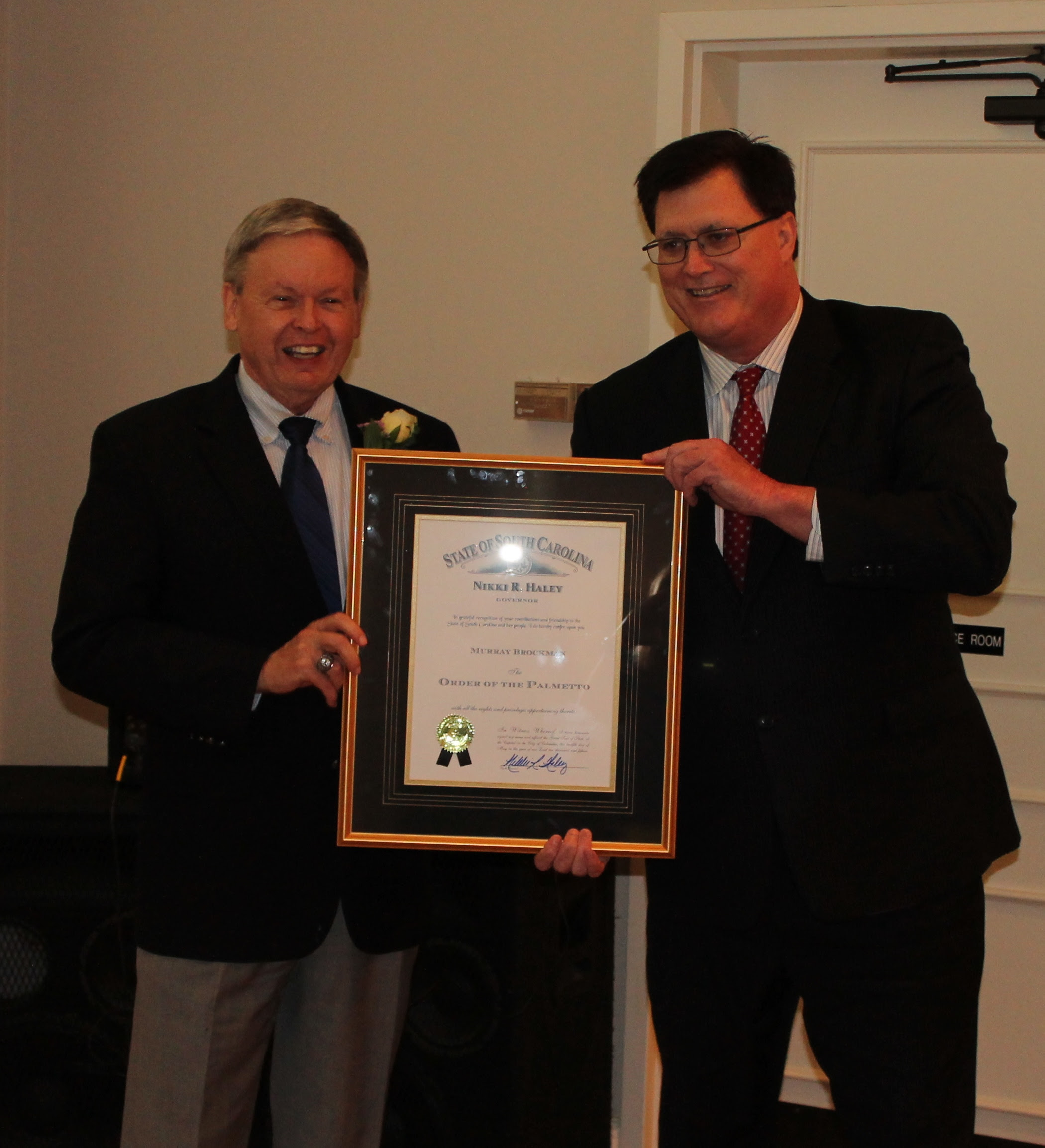 Dr. Brockman receiving the Order of the Palmetto from Speaker Lucas