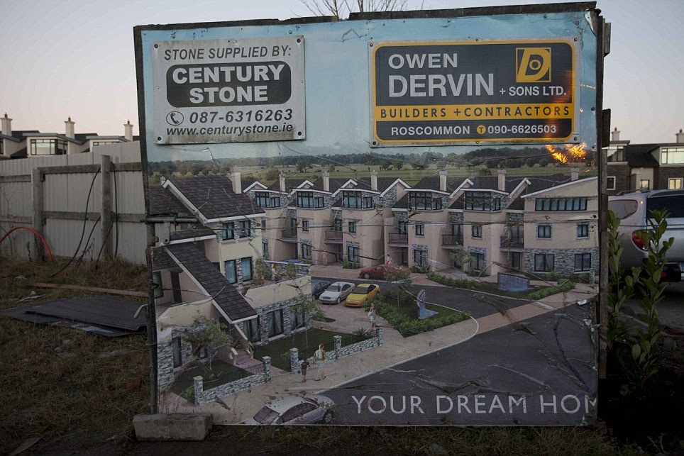 Broken dreams: A billboard which offered families the chance to buy their 'dream home' during the boom years stands as a painful reminder of the recession