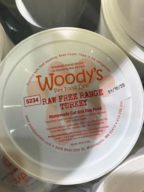 Woody's Raw Free Range Turkey Pet Food container label sell by date 01/10/20