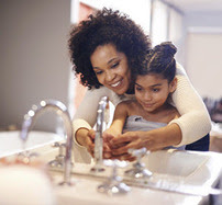 Mother and daughter washing hands