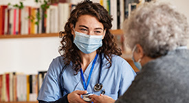 Nurse speaking to elderly patient