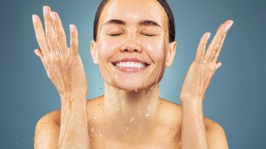 Young Woman Washing Face Smiling