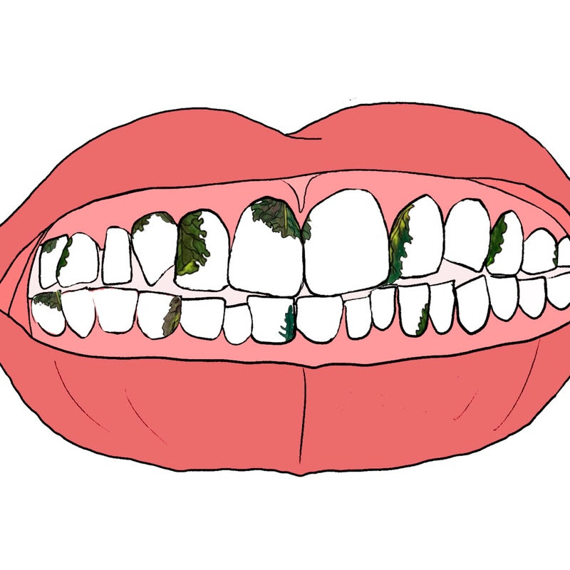 An illustration of a mouth with spinach in the teeth.
