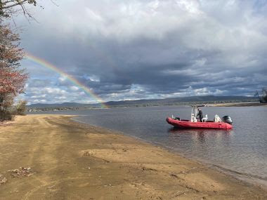 Ranger rescue boat at shore with a view of the rainbow in the background