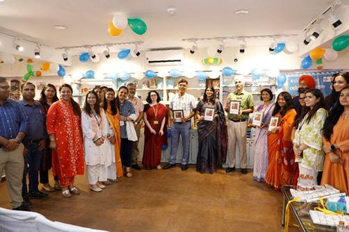 A group of people standing in a roomDescription automatically generated