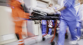 Nurses, EMS, doctors rushing patient through hospital