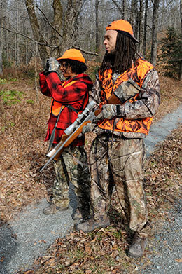 A man and a woman in hunting camo.