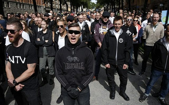 Supporters of the neo-Nazi Nordic Resistance Movement chant slogans during a demonstration at the Kungsholmstorg square in Stockholm, Sweden on August 25, 2018. (AFP/ TT News Agency / Fredrik Persson)