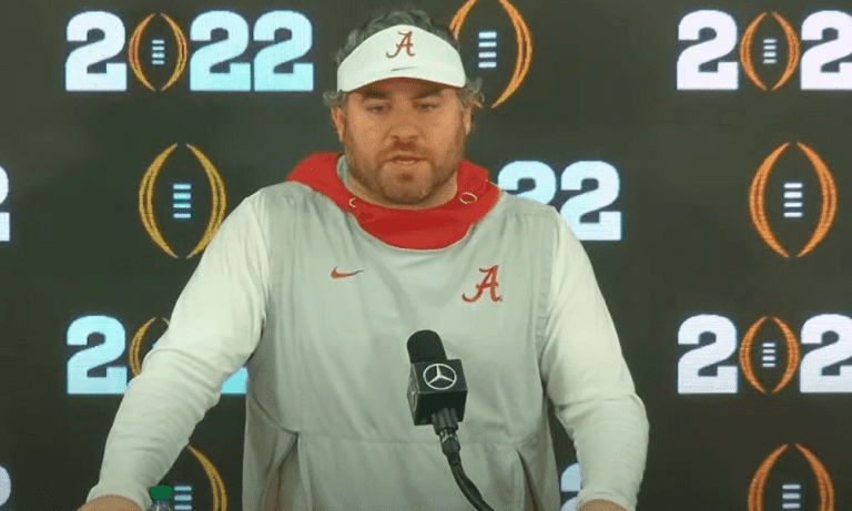 Pete Golding at the podium for CFP media day for Alabama