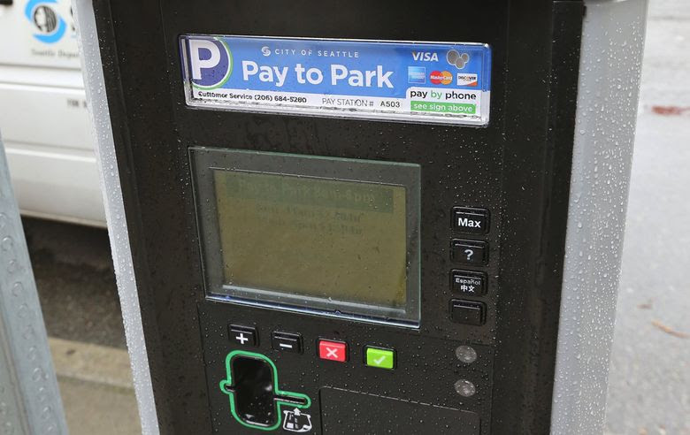 The city of Seattle is setting new on-street parking rates this fall in areas throughout the city. Some rates will rise while others will fall. (Greg Gilbert / The Seattle Times)