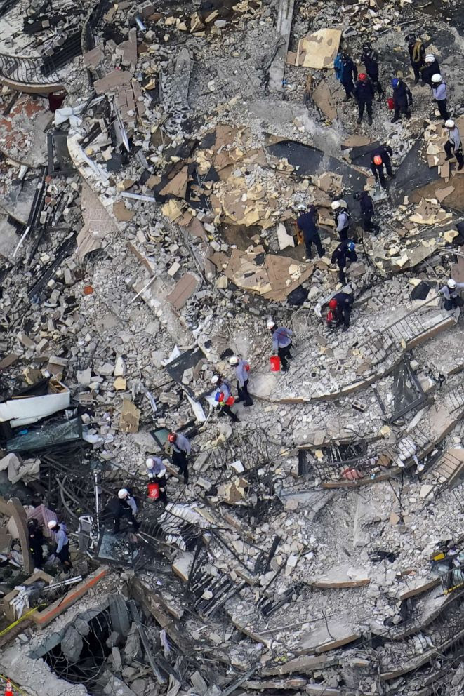 Overhead view of rescuers combing through the debris