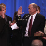 Bill Walker puts his hand on his family Bible as he takes the oath of office to become the 11th governor of the state of Alaska on Dec. 1, 2014 in Juneau, Alaska's Centennial Hall.
(James Brooks photo)