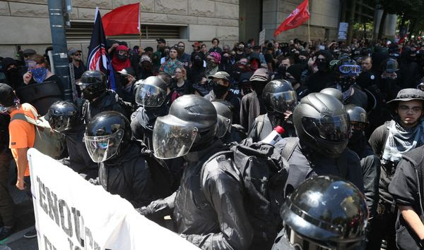 In this file photo, protesters including Rose City Antifa, are shown in downtown Portland, Ore., Saturday, June 29, 2019. (Dave Killen/The Oregonian via AP) **FILE**