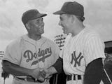 Brooklyn Dodgers&#39; Roy Campanella, left, and New York Yankees&#39; Yogi Berra, rival catchers, exchanged greetings before an exhibition game on March 25, 1955.(AP Photo) **FILE**