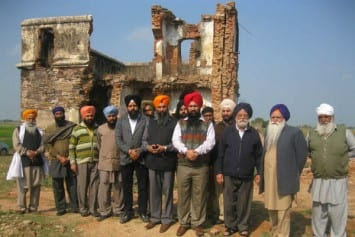 Sikh activists, led by Manwinder Singh GIaspura outside the Hond Chillar site where 32 Sikhs were burnt alive