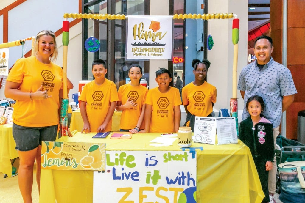 A Lemonade Alley team sets up at Pearlridge Center. Opposite page, left: Participants of Hawaii Biz Kids sell self-made products. Opposite page, right: Katrina Kuo meets First Lady Dawn Amano-Ige at a 2018 Project Lemon Tree event. | Photo: courtesy of Cliff Kimura