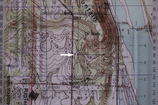 military protractor on top of topo topographic map