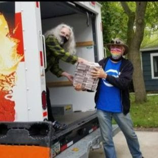 Volunteers unloading bundles and bales of Voter Guides in 2020