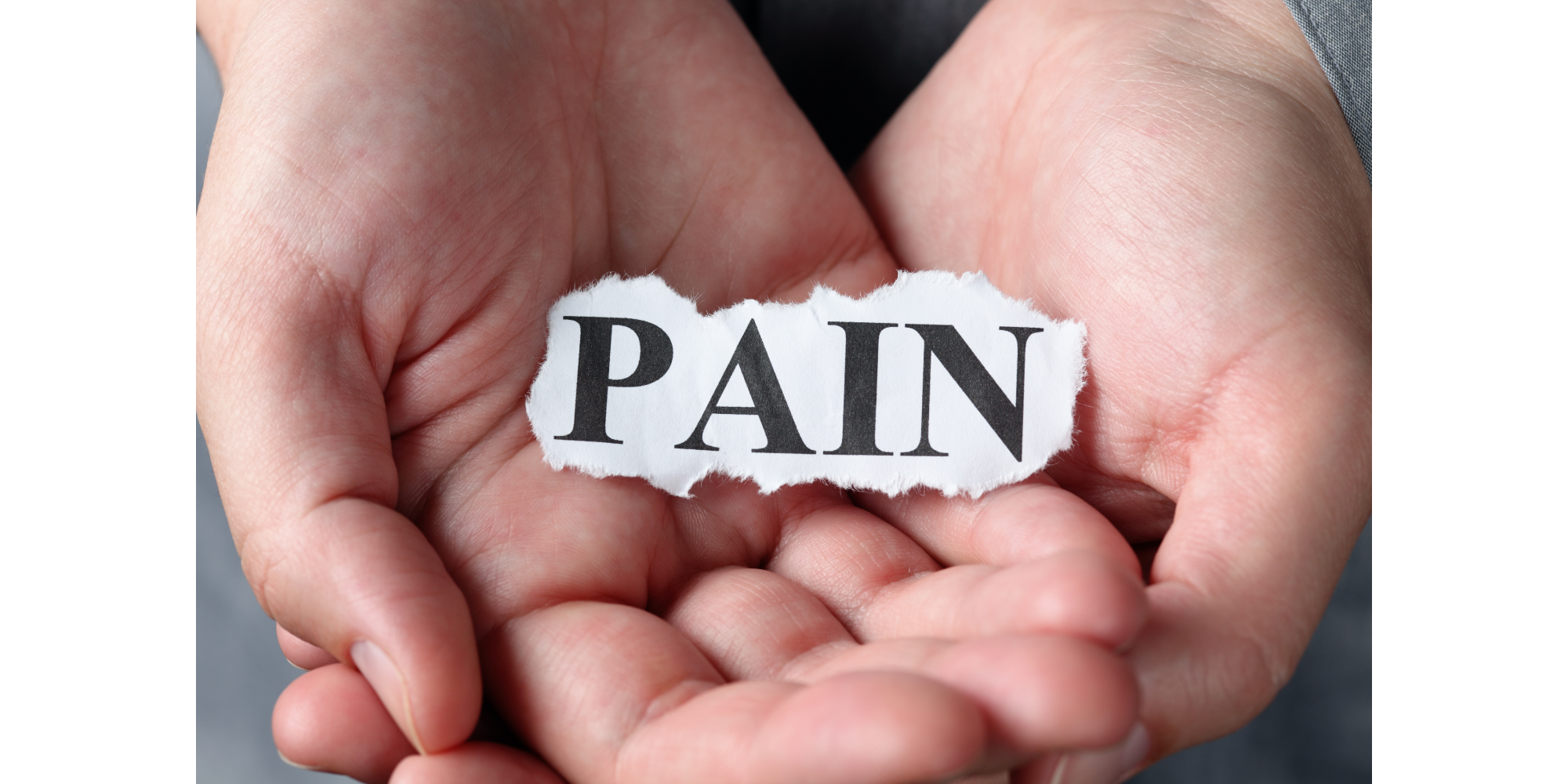 Hands holding sign that says pain for pain relief with cbd