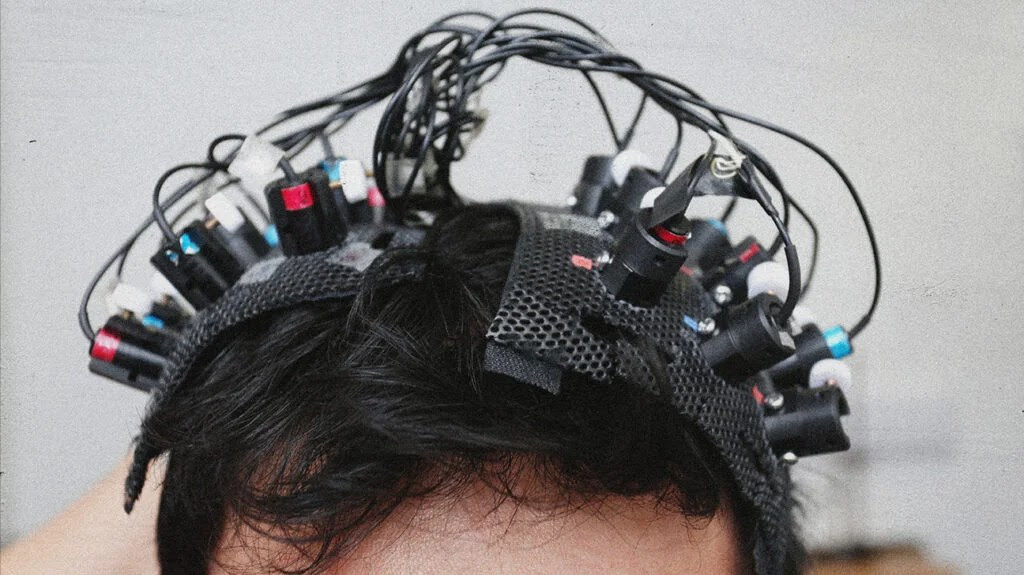 Someone with EEG sensors on their scalp