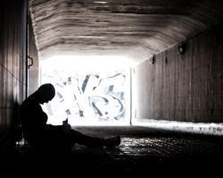 homeless person in a tunnel