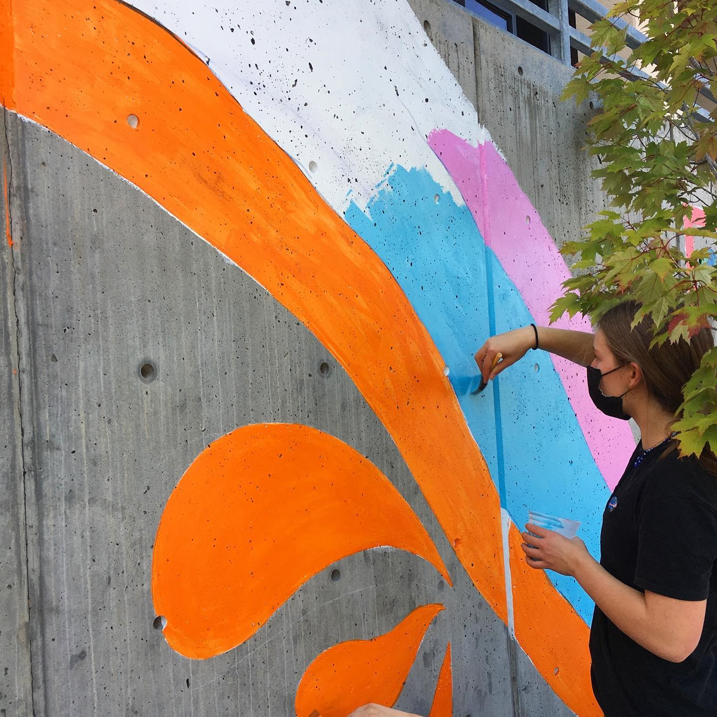 Person painting the mural