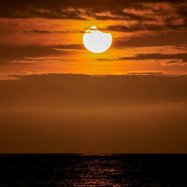 It was a partial solar eclipse sunset from the Big Island of Hawaii on March 8, 2016, said Chris Tinker. Thanks, Chris!