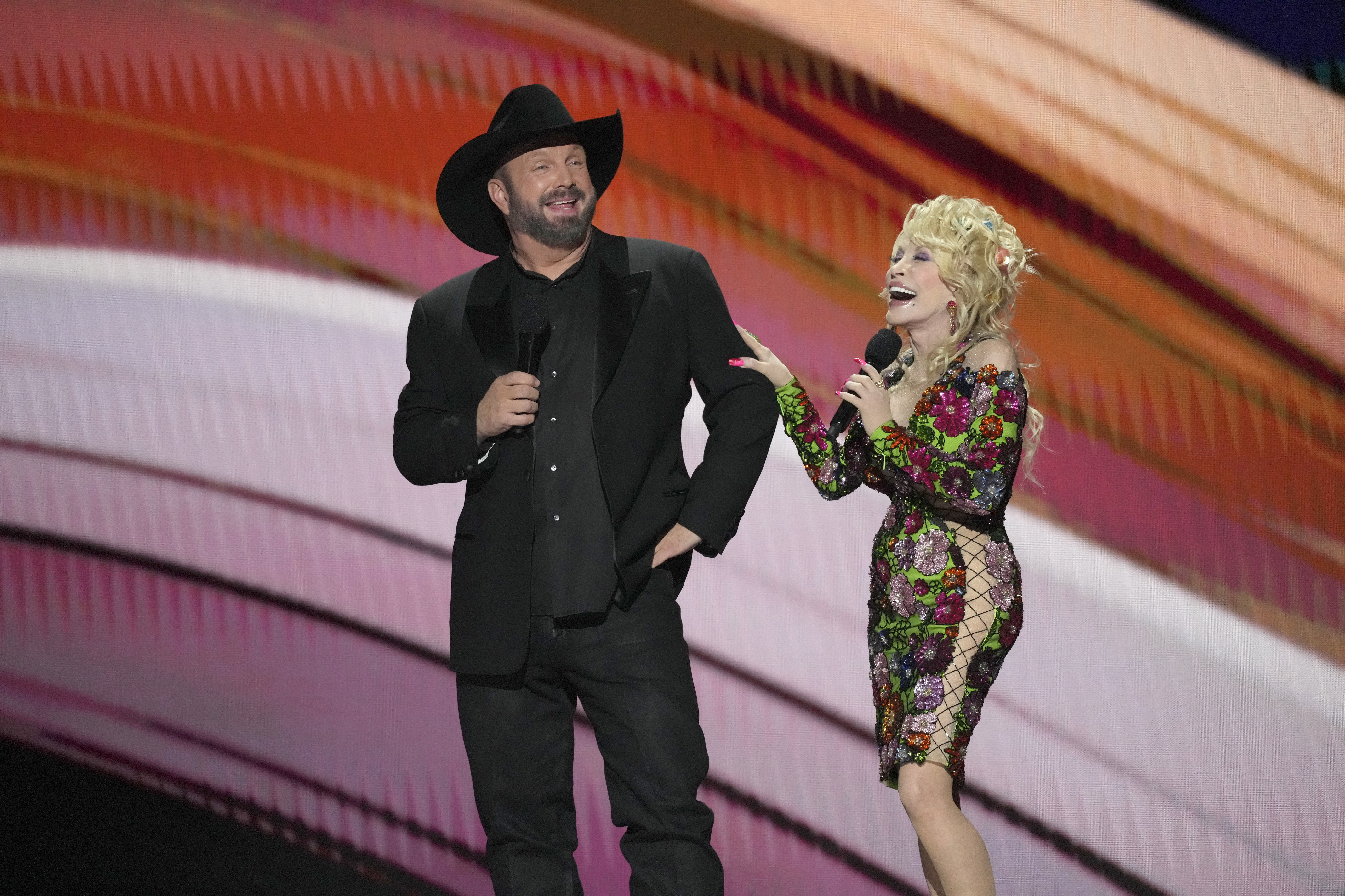 Hosts Garth Brooks, left, and Dolly Parton speak at the 58th annual Academy of Country Music Awards